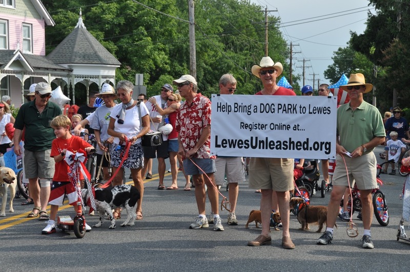 A group of Lewes residents used the city's Fourth of July DooDah Parade to raise interest in creating a dog park in the city. In a dog park, owners could let their pets run free, unrestricted by a leash. Lewes city ordinance requires dogs to be on a leash at all times. BY RON MACARTHUR